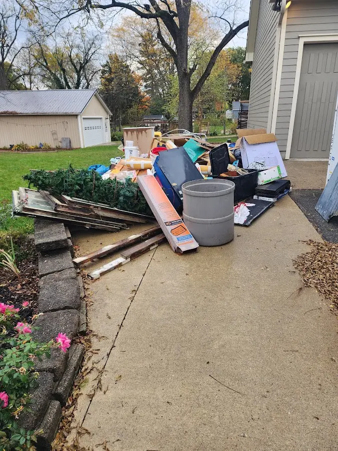 Dumpster being loaded with debris for 12 Yard Dumpster Rental in Country Club Estates